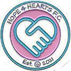 A logo with a heart and handshake

Description automatically generated