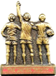 A bronze statue of a group of men holding a torch

Description automatically generated