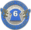 A blue and silver badge with a number and lions

Description automatically generated